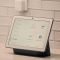 Modern smart home interior with a tablet displaying an energy dashboard and a smart thermostat.
