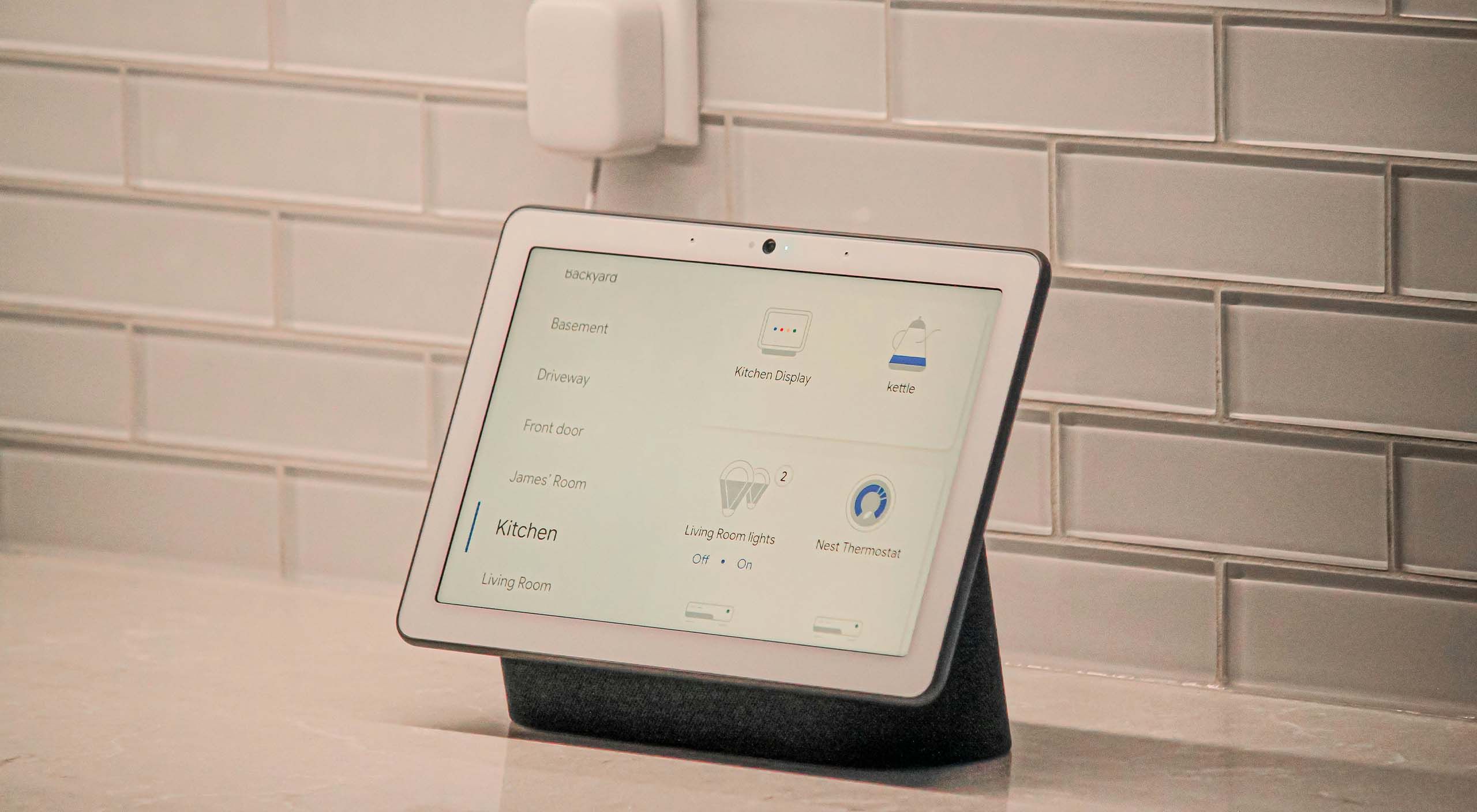 Modern smart home interior with a tablet displaying an energy dashboard and a smart thermostat.