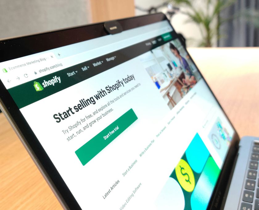 Comparison of ecommerce platforms, shopify shown on a laptop screen