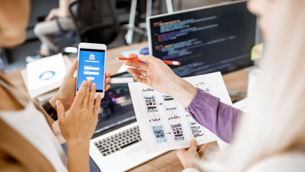 Women working on a mobile app for a bank, design and implementation